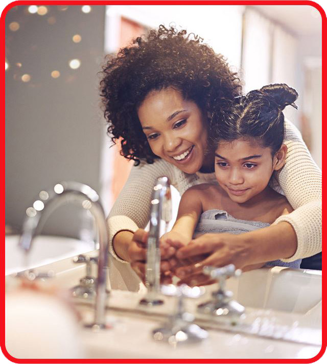 mother teaching daughter on how to wash her hands properly
