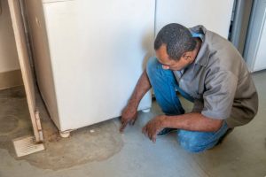 Man Inspecting Slab Leak Repair