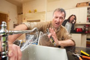Emergency plumbing: water leakage from tap. Plumber stopping water leakage